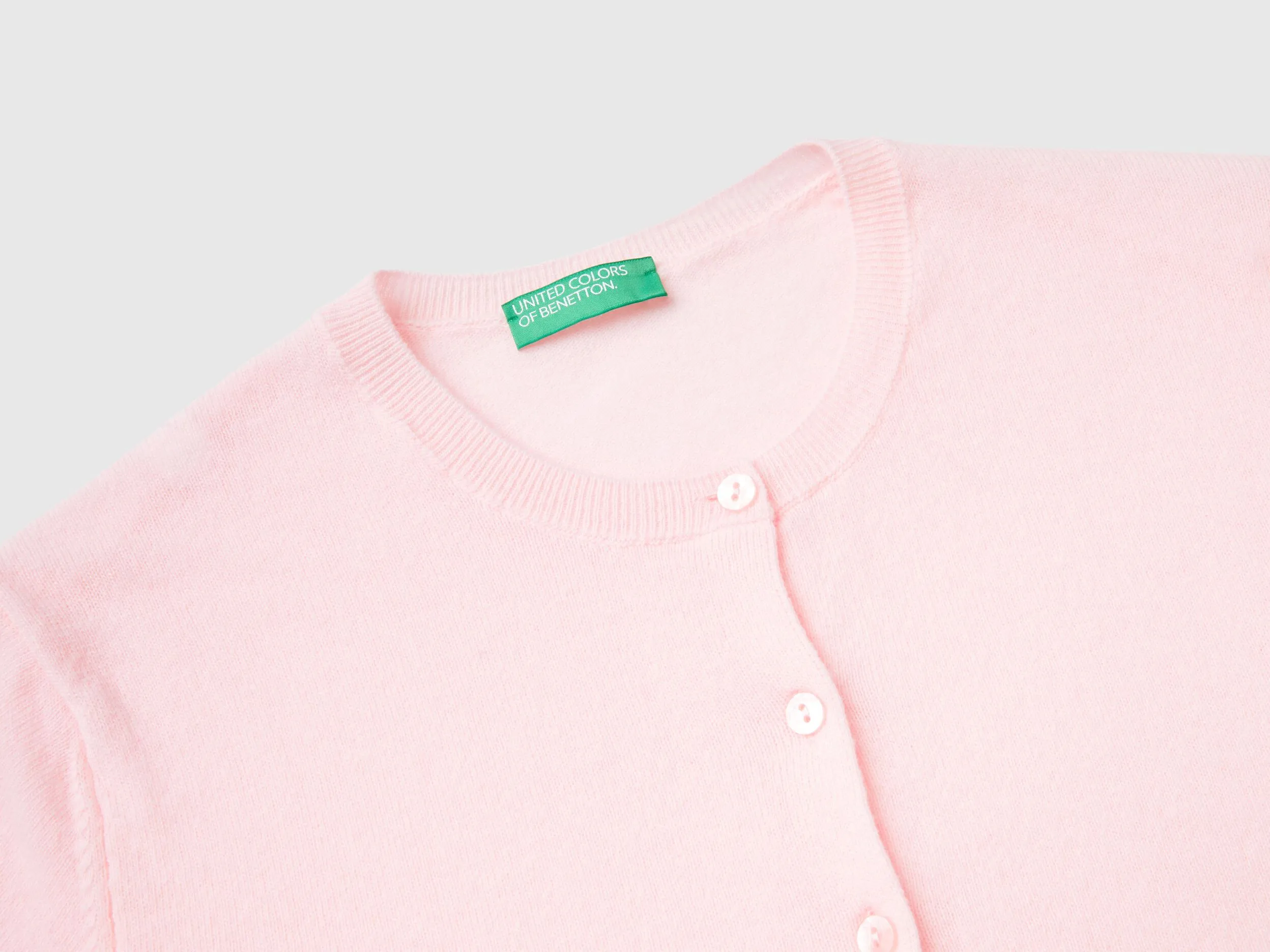 Cárdigan de cuello redondo rosa claro de pura lana merina